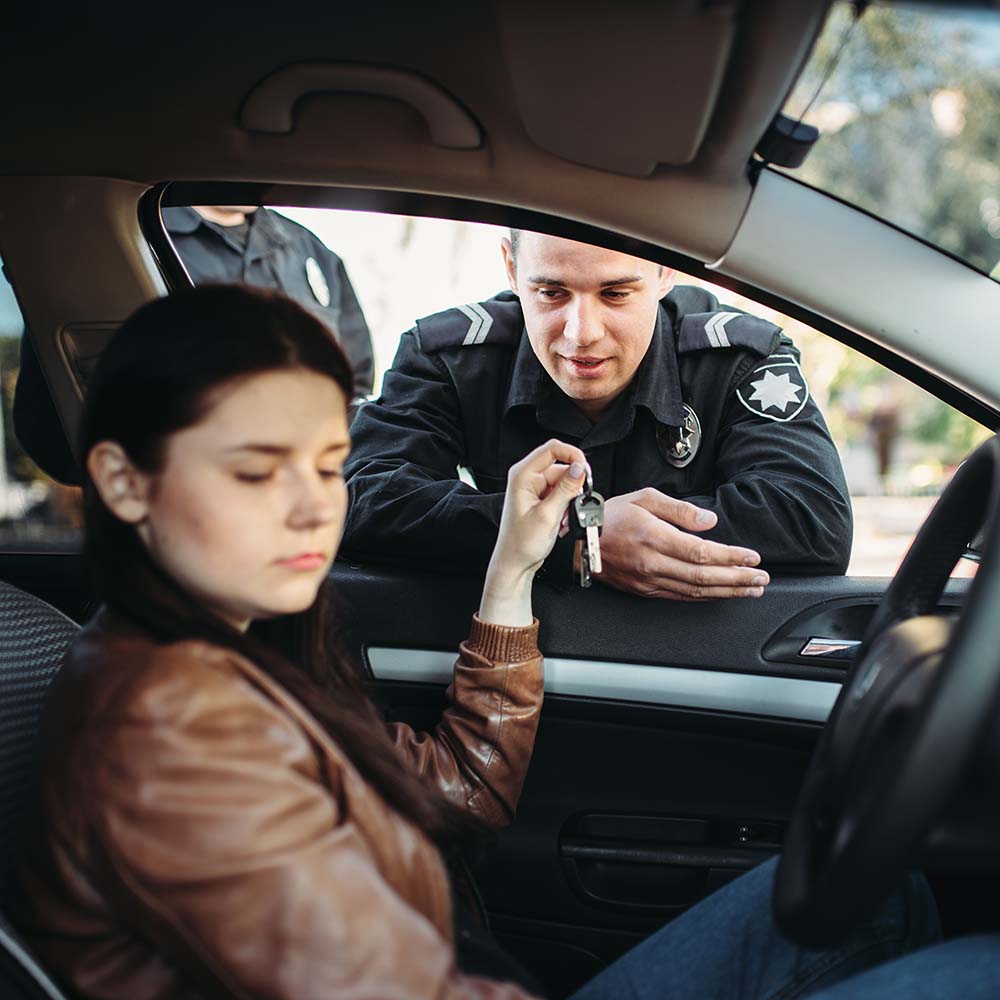 police-officers-in-uniform-check-female-driver-BYETQDW.jpg